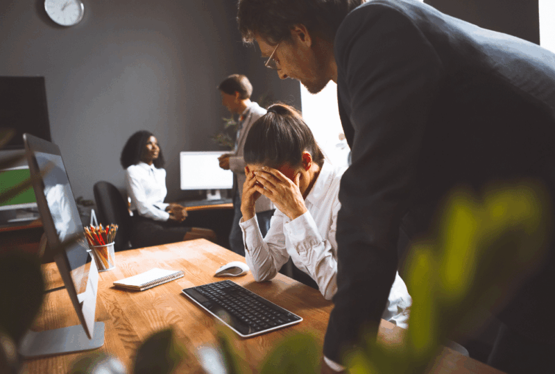 Image is of a woman regretting her hiring decision with one of her fellow workers, concept of how to avoid hiring mistakes