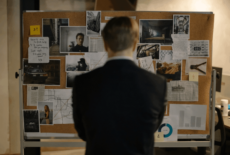 Image is of an investigator in front of a board, concept of how investigators find missing persons