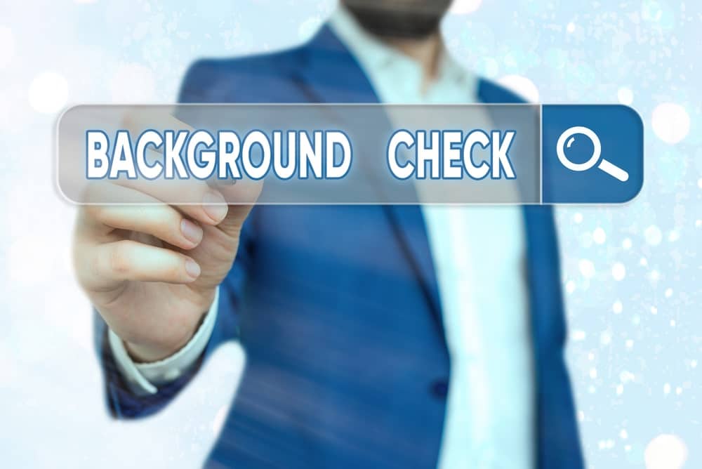 image of a man holding a pencil while doing a background check. concept of a background check being done in Seattle Washington