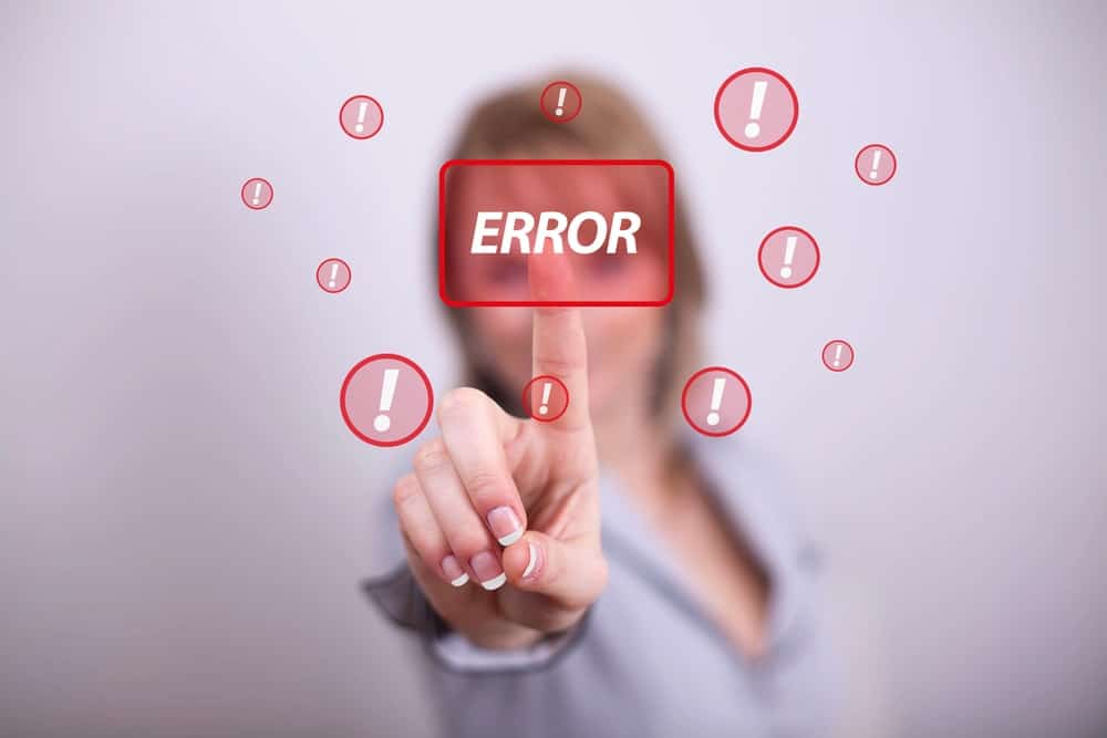 Woman pressing digital “ERROR” button, highlighting background check errors