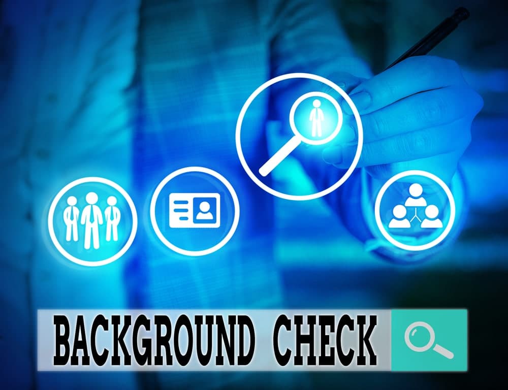 Background check concept with magnifying glass.