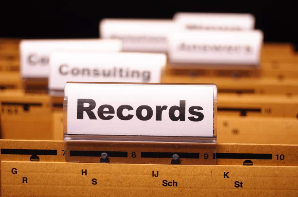 Image is of an organized filing system labeled records, illustrating how structured record keeping supports accurate asset investigations