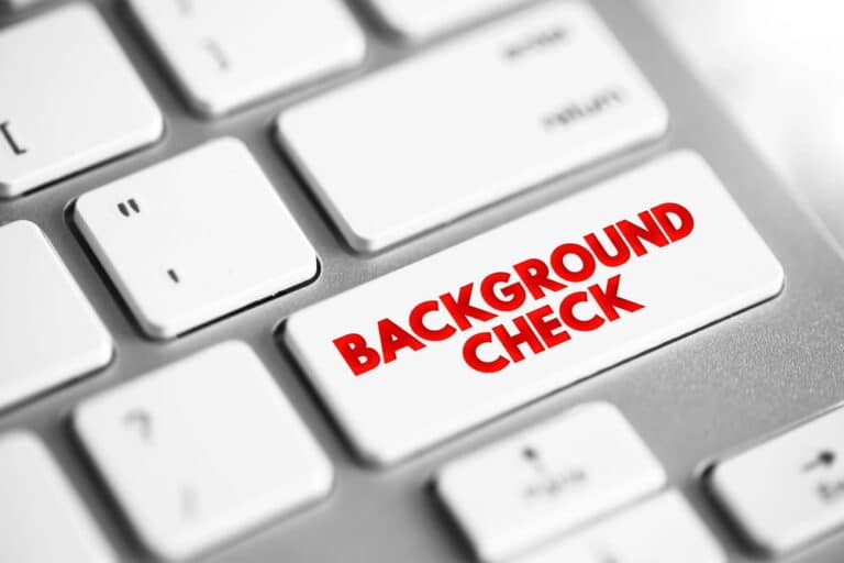 Image is of a keyboard button labeled background check, representing criminal record screening and employment in WA